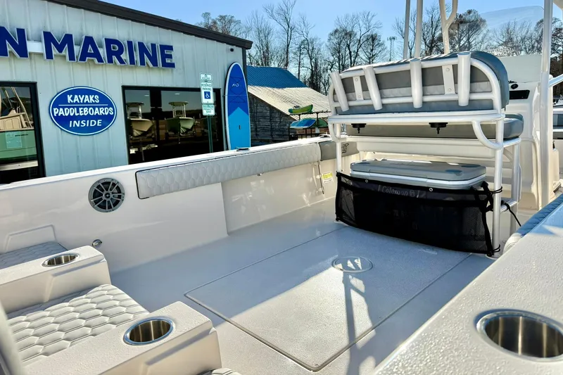 Slide: The Image of 2026 Carolina Skiff 26 Ultra Elite boat interior with seating and storage, near marine store. - 35