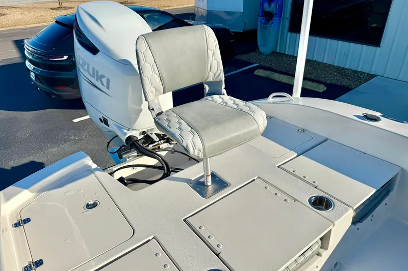 Slide: The Image of 2026 Carolina Skiff 26 Ultra Elite boat with Suzuki outboard motor and cushioned seat. - 36