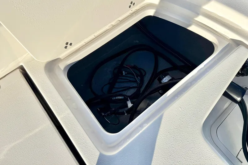 Slide: The Image of Storage compartment of 2026 Carolina Skiff 26 Ultra Elite boat, featuring internal wiring. - 41