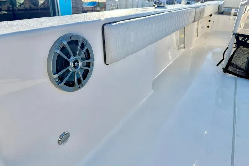 Slide: The Image of 2026 Carolina Skiff 26 Ultra Elite boat interior with speaker and cushioned seating. - 44