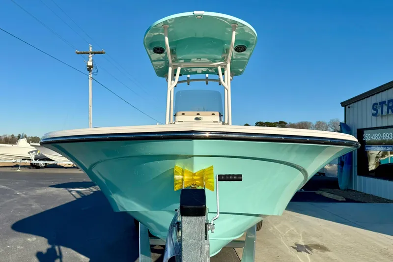 Slide: The Image of 2026 Carolina Skiff 26 Ultra Elite boat, light blue hull, parked outdoors. - 8