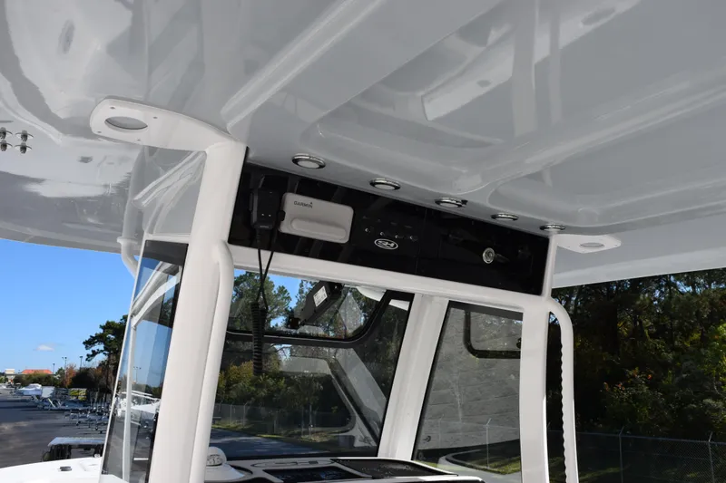 Slide: The Image of 2026 Sea Hunt Ultra 305 Coffin Box boat console with electronics and canopy. - 10