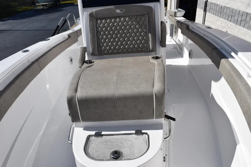 Slide: The Image of 2026 Sea Hunt Ultra 305 Coffin Box boat interior with cushioned seating and storage. - 13