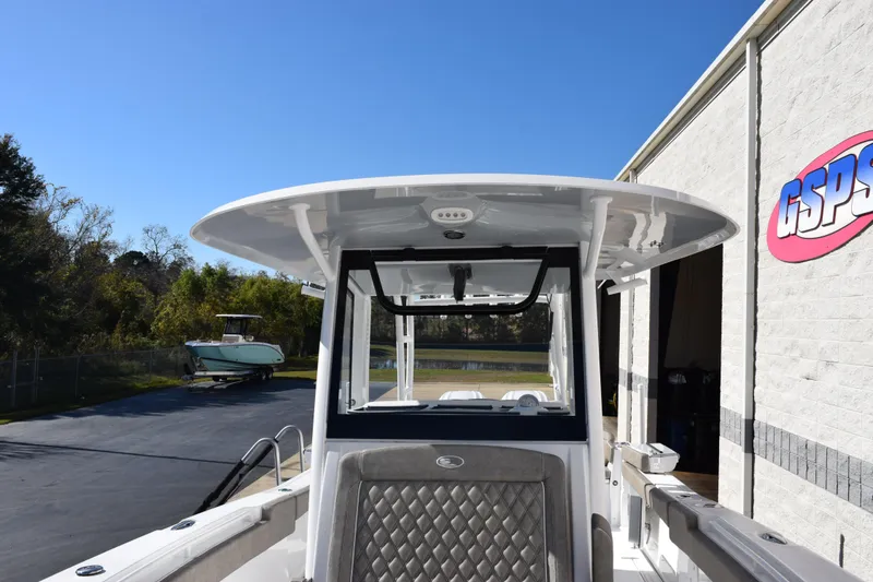 Slide: The Image of 2026 Sea Hunt Ultra 305 Coffin Box boat at dealership, sunny day. - 14