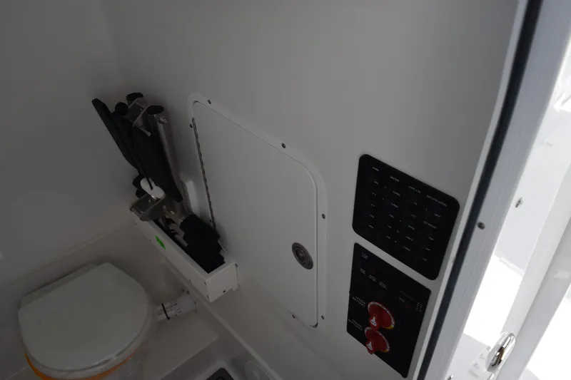 Slide: The Image of Interior of 2026 Sea Hunt Ultra 305 Coffin Box boat, featuring control panel and storage. - 18