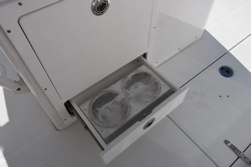 Slide: The Image of 2026 Sea Hunt Ultra 305 Coffin Box with open storage drawer on deck. - 19