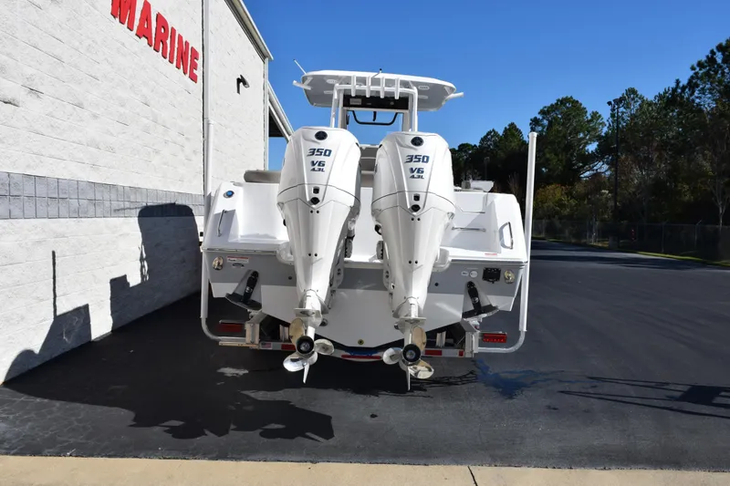 Slide: The Image of 2026 Sea Hunt Ultra 305 Coffin Box with dual 350 V6 engines, parked outdoors. - 5