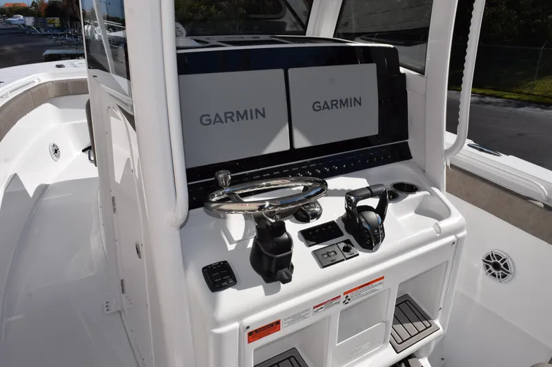 Slide: The Image of 2026 Sea Hunt Ultra 305 Coffin Box boat console with dual Garmin displays. - 9
