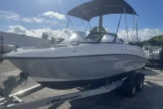 Slide: The Image of 2023 Bayliner VR5 Bowrider OB on trailer, under sunny sky with protective canopy. - 3