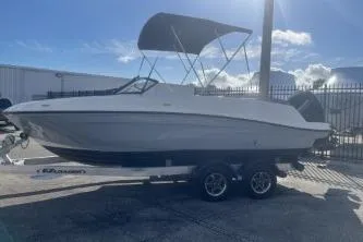 Slide: The Image of 2023 Bayliner VR5 Bowrider OB boat with canopy on trailer, sunny day. - 4