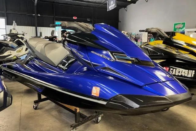 The Image of 2014 Yamaha WaveRunner FX Cruiser HO in showroom, vibrant blue color, sleek design. - 1