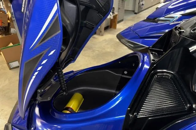 Slide: The Image of 2014 Yamaha WaveRunner FX Cruiser HO with open storage compartment, showcasing sleek blue design. - 13