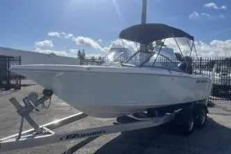 Slide: The Image of 2023 Key West 203 DFS boat on trailer under sunny sky. - 3