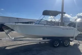 Slide: The Image of 2023 Key West 203 DFS boat on trailer, parked outdoors under clear sky. - 4