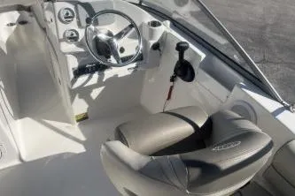Slide: The Image of 2023 Key West 203 DFS boat interior with steering wheel and seating. - 7
