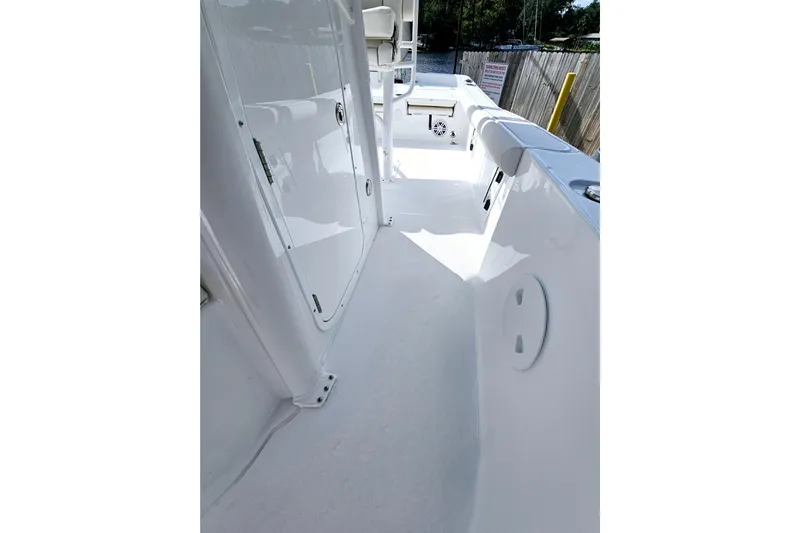 Slide: The Image of 2026 Sea Hunt BX 25 FS boat interior, showcasing sleek white deck and storage compartments. - 14