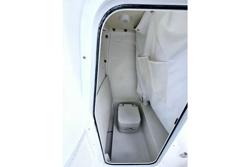 Slide: The Image of 2026 Sea Hunt BX 25 FS boat interior with compact marine toilet. - 15