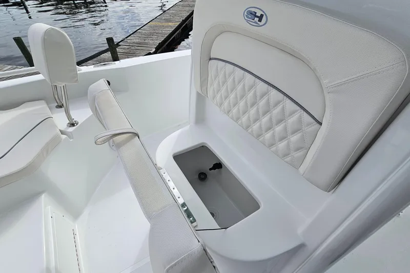 Slide: The Image of 2026 Sea Hunt BX 25 FS boat interior with cushioned seating and storage compartment. - 22
