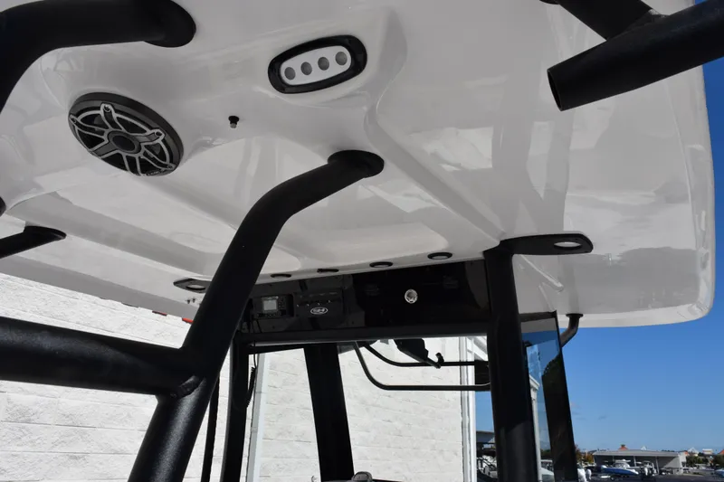 Slide: The Image of 2026 Sea Hunt Ultra 285 SE boat T-top with speaker and lighting features. - 10