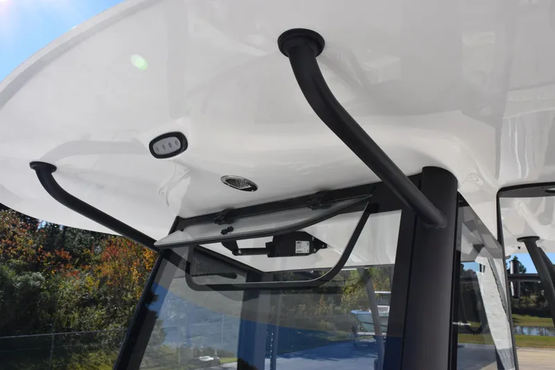 Slide: The Image of 2026 Sea Hunt Ultra 285 SE boat roof with black handles and lighting. - 16