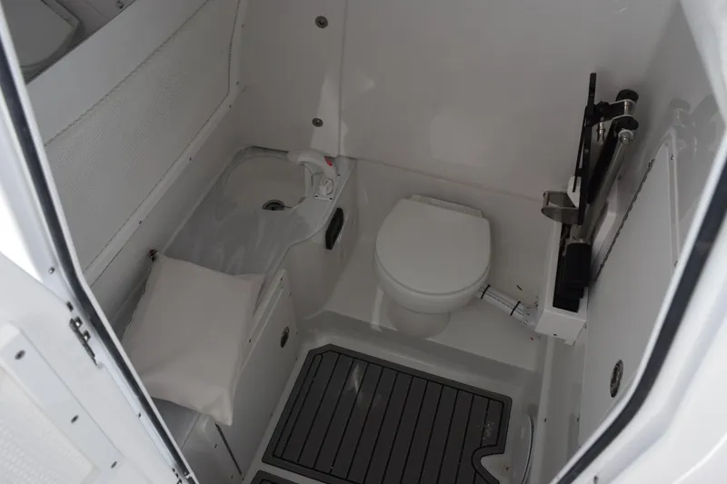 Slide: The Image of 2026 Sea Hunt Ultra 285 SE boat interior with compact bathroom amenities. - 19