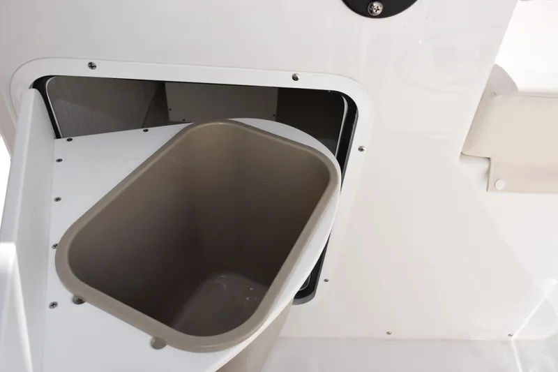Slide: The Image of Storage compartment with bin on 2026 Sea Hunt Ultra 285 SE boat. - 22