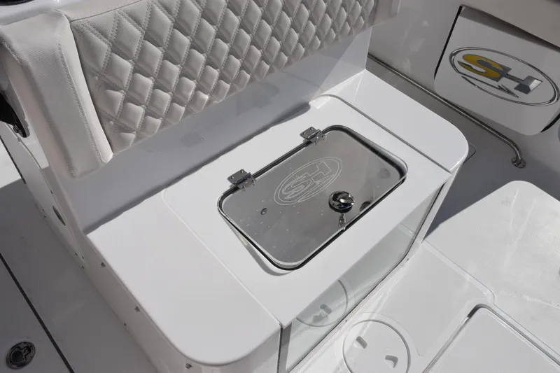 Slide: The Image of 2026 Sea Hunt Ultra 285 SE boat interior with quilted seating and storage compartment. - 24