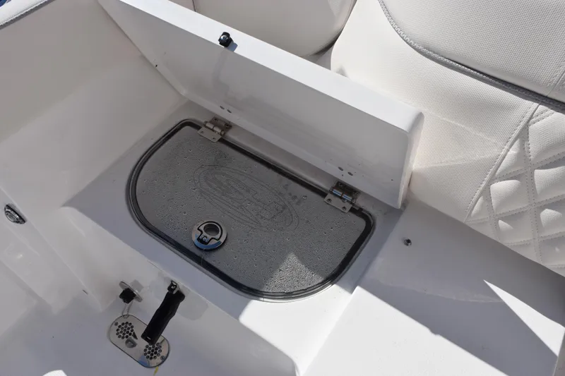 Slide: The Image of 2026 Sea Hunt Ultra 285 SE boat storage compartment with white cushioned seating. - 26