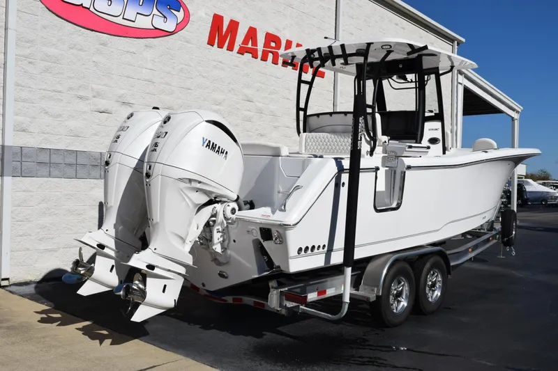 Slide: The Image of 2026 Sea Hunt Ultra 285 SE boat with dual Yamaha engines on a trailer. - 4