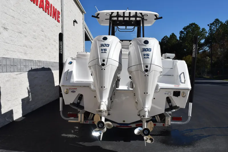 Slide: The Image of 2026 Sea Hunt Ultra 285 SE boat with dual 300 V6 engines, parked outdoors. - 5
