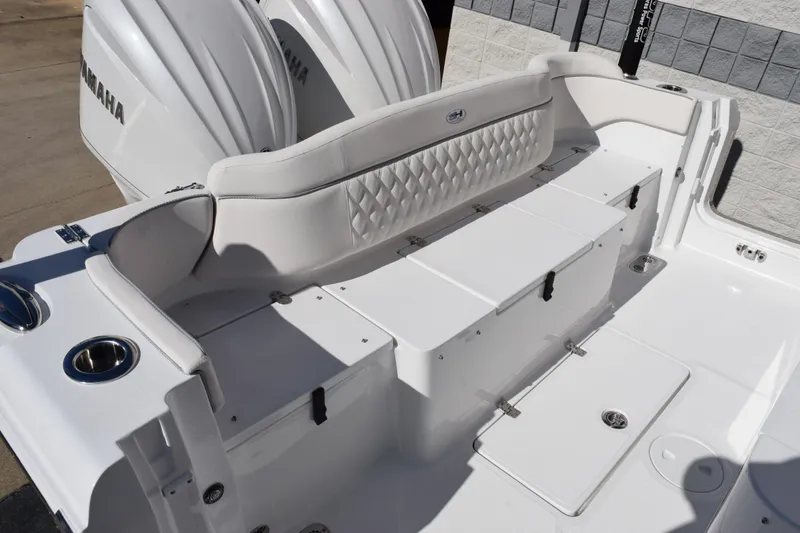 Slide: The Image of 2026 Sea Hunt Ultra 285 SE boat interior with Yamaha engines, featuring white seating and storage. - 7