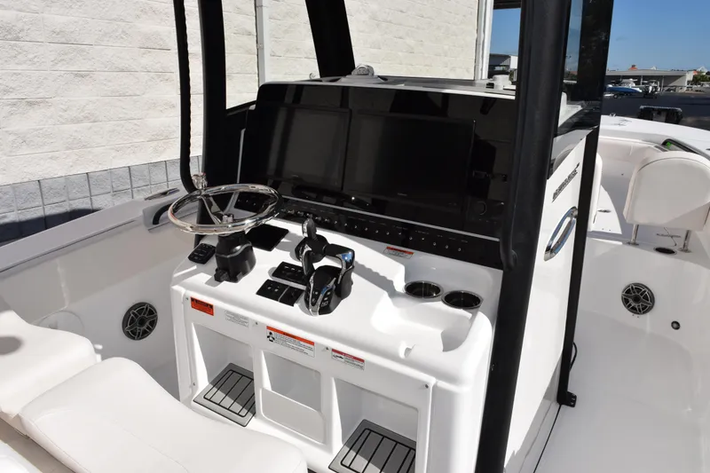Slide: The Image of 2026 Sea Hunt Ultra 285 SE boat console with steering wheel and modern controls. - 9