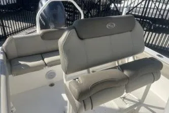 Slide: The Image of 2022 Key West 219 FS boat interior with cushioned seating and console. - 10