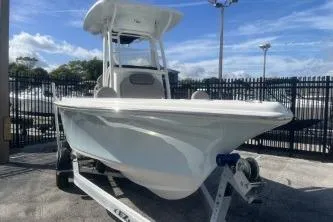 Slide: The Image of 2022 Key West 219 FS boat on trailer, parked outdoors under a clear sky. - 2
