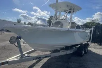 Slide: The Image of 2022 Key West 219 FS boat on trailer under a sunny sky. - 3