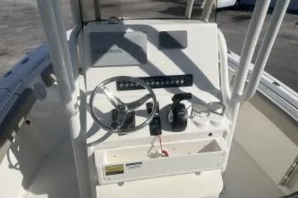 Slide: The Image of 2022 Key West 219 FS boat console with steering wheel and controls. - 7