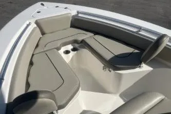 Slide: The Image of 2022 Key West 219 FS boat interior with cushioned seating and cup holders. - 8