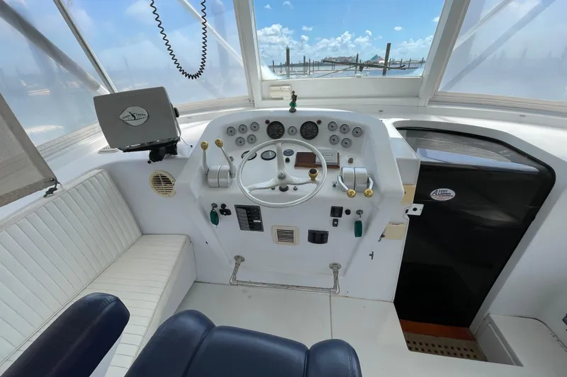 Slide: The Image of Helm of 2000 Mockingbird Marine Custom 48 boat with steering wheel and controls. - 11