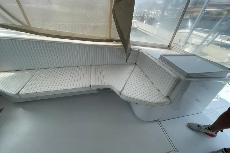 Slide: The Image of White seating area on a 2000 Mockingbird Marine Custom 48 boat. - 14