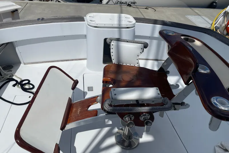 Slide: The Image of Cockpit of 2000 Mockingbird Marine Custom 48 with fishing chair and rod holders. - 18