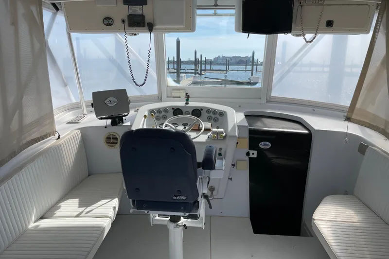 Slide: The Image of Helm of 2000 Custom Mockingbird Marine 48 Sportfish with seating and navigation equipment. - 27