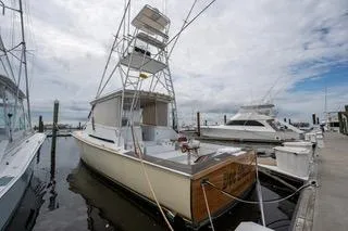 Slide: The Image of Mockingbird Marine Custom 48 boat, 2000 model, docked at a marina under cloudy skies. - 3