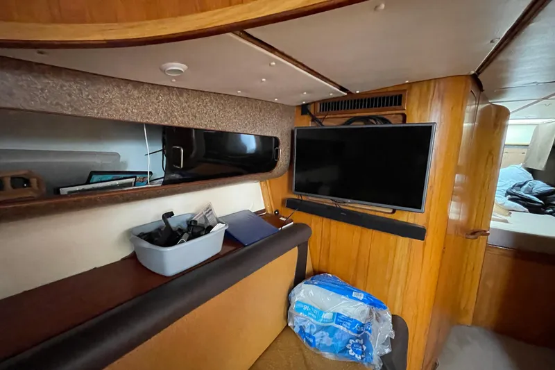 Slide: The Image of Interior of 2000 Custom Mockingbird Marine 48 Sportfish with TV and storage area. - 32