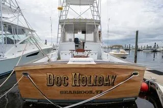 Slide: The Image of Mockingbird Marine Custom 48 boat, 2000 model, docked with "Doc Holiday" nameplate. - 4
