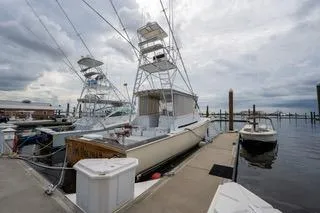 Slide: The Image of 2000 Mockingbird Marine Custom 48 yacht docked at marina under cloudy sky. - 5