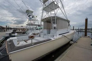 Slide: The Image of 2000 Mockingbird Marine Custom 48 yacht docked at marina under cloudy sky. - 6