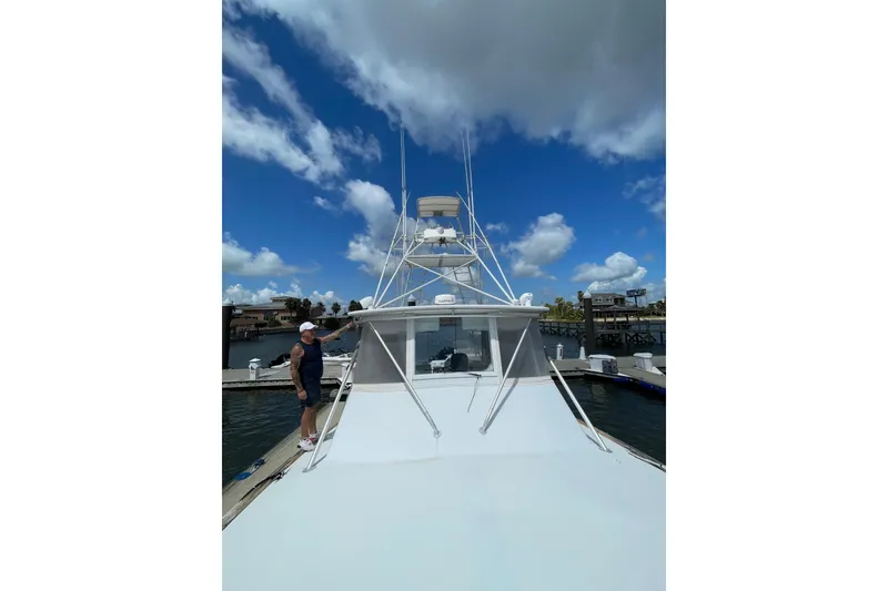 Slide: The Image of Man on Mockingbird Marine Custom 48 yacht, 2000 model, docked under blue sky. - 7