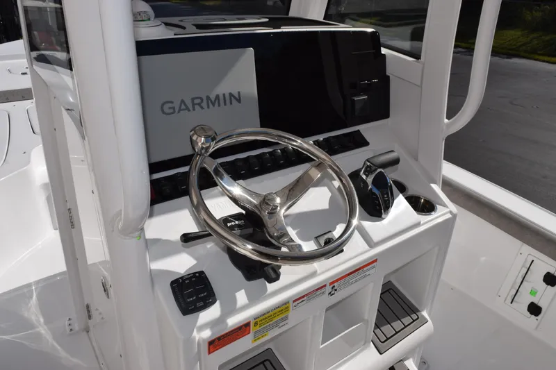 Slide: The Image of 2026 Sea Hunt BX 25 FS boat console with Garmin navigation system and steering wheel. - 12