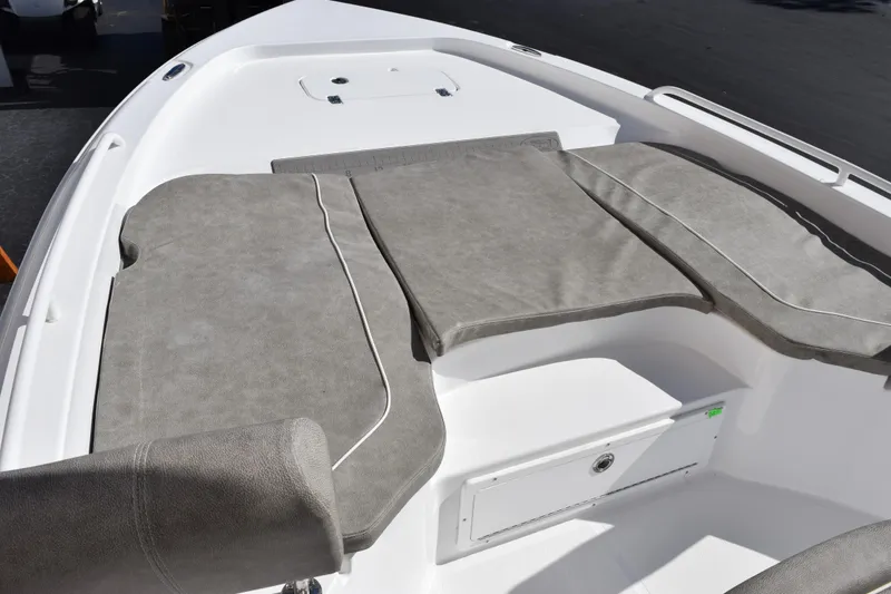 Slide: The Image of 2026 Sea Hunt BX 25 FS boat with cushioned seating area, gray upholstery. - 18