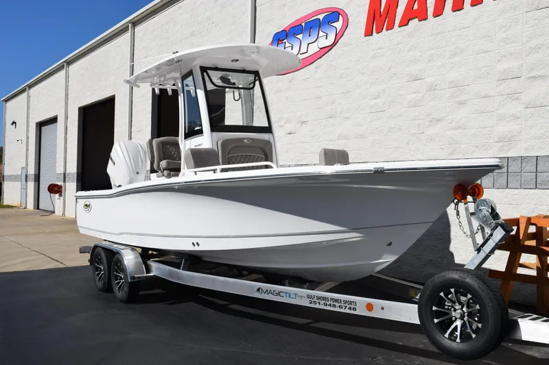 Slide: The Image of 2026 Sea Hunt BX 25 FS boat on trailer outside dealership. - 2